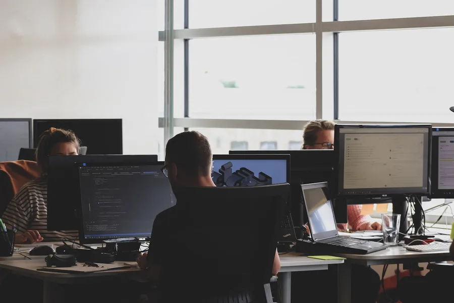 IT team monitoring multiple screens in a network operations setting